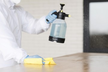 close up man holding disinfectant bottle v2